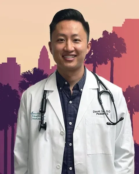 Dr. David La, an Asian man, smiling while wearing a white coat and stethoscope around his neck. 