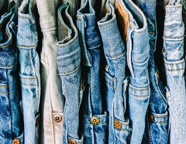 A group of denim jeans hanging