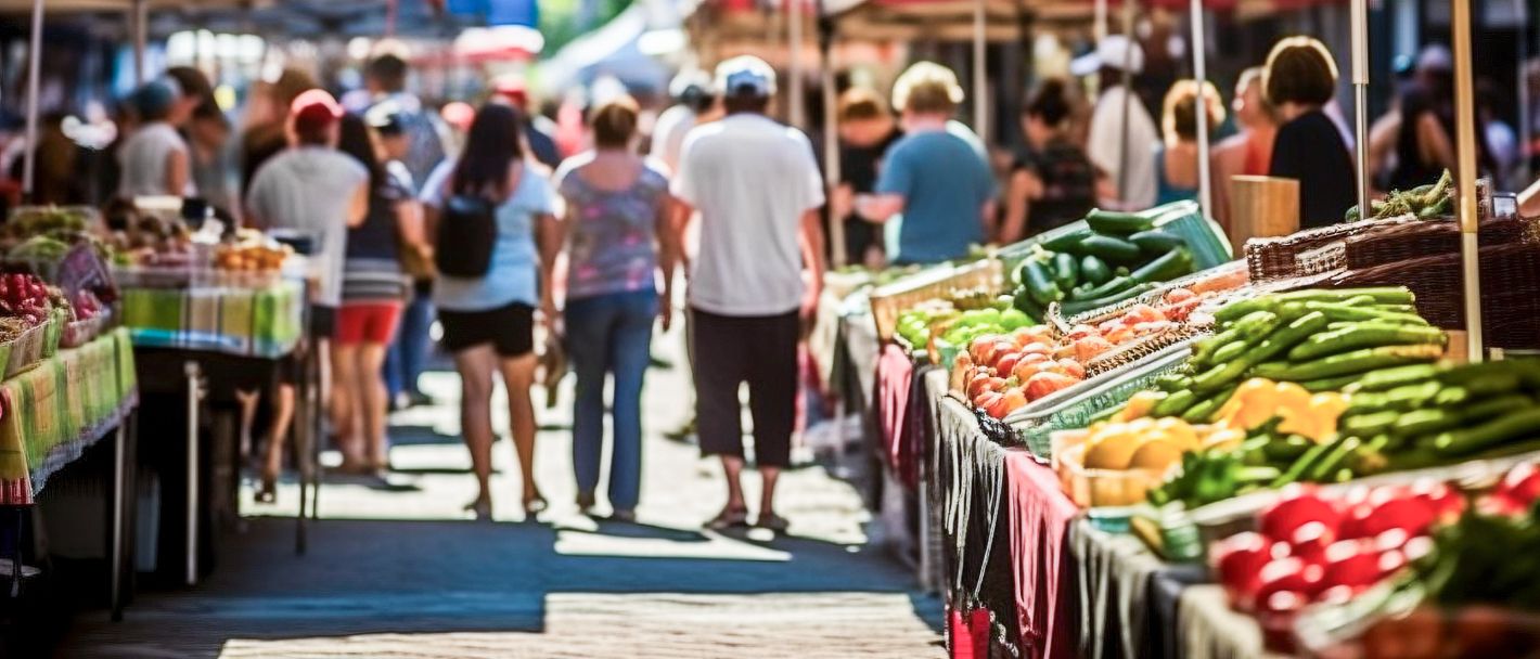 Bustling Greenville, SC market: Crowds shop for fresh fruits in vibrant farmers' market scene.