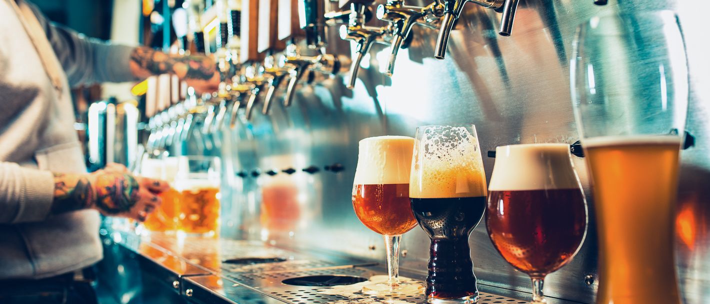  A row of colorful draft beer taps, showcasing the diverse and flavorful beer selection in Greenville, SC's vibrant scene.