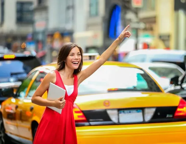 Lady smiling while hailing a cab