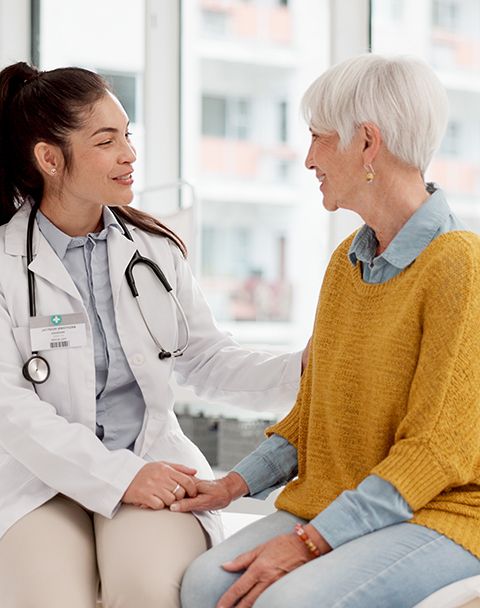 Oncology physician, a woman who is Asian in a white-coat with her elderly patient.