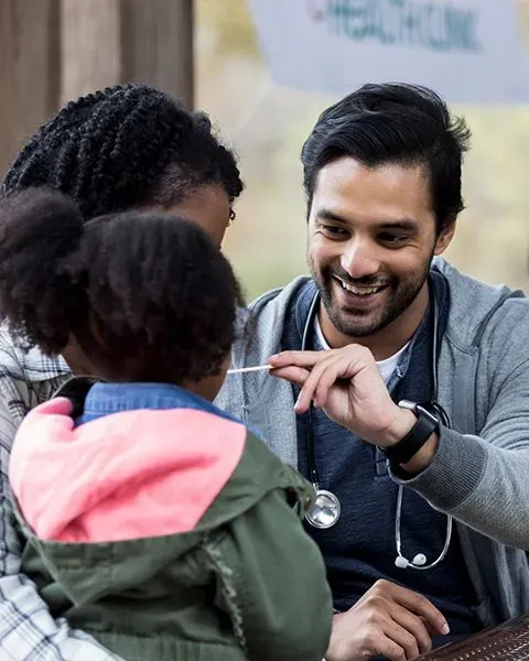 A physician giving an exam on a child patient