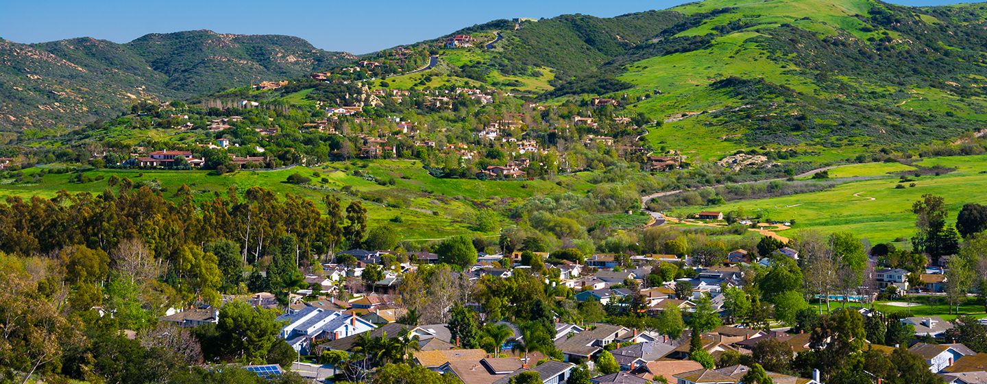 Homes surrounded by green hills in Orange, California.