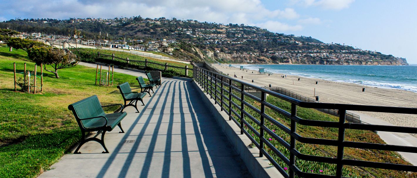 Benches overlooking a beach at Miramar Park in Torrance State Beach. in California.