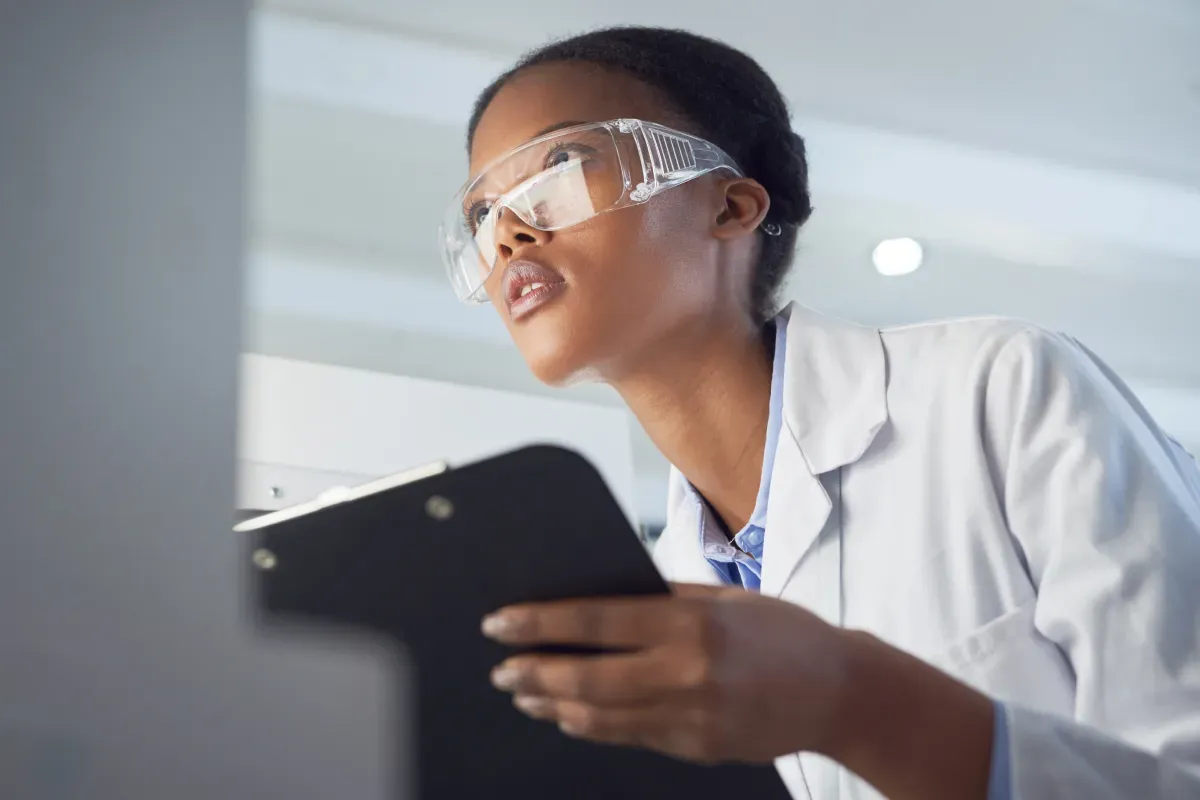 Woman doctor in lab environment looking at screen