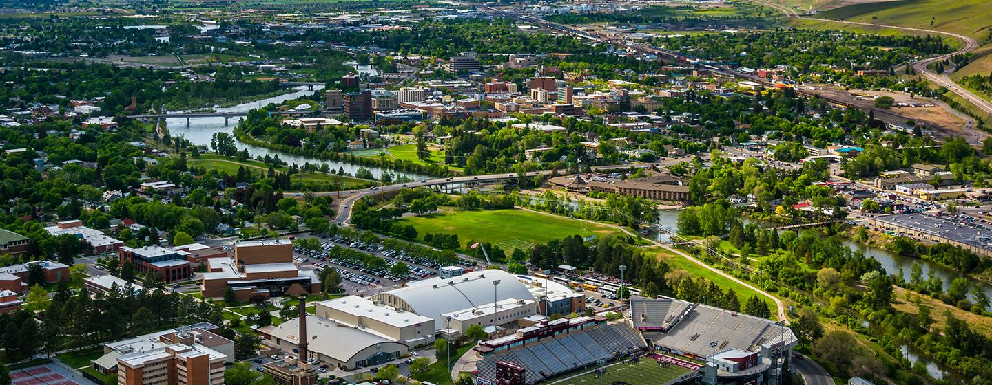 Aerial view of a city surrounded by a forest and trees in the state of Montana.