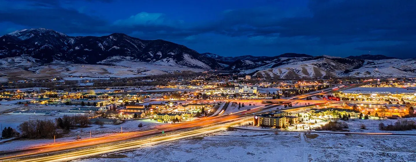 Downtown at night with with lights from homes and cars in the state of Montana.