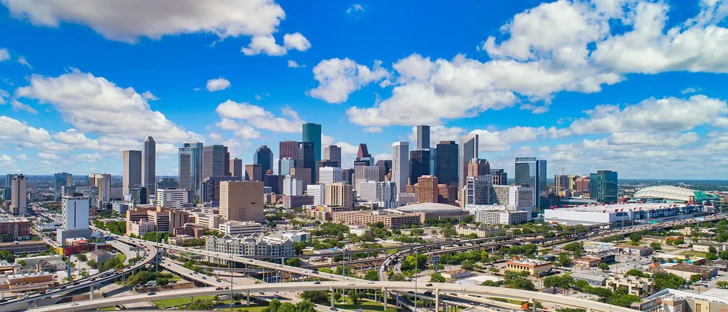 Downtown cityscape view with a calm river in the foreground in Texas.