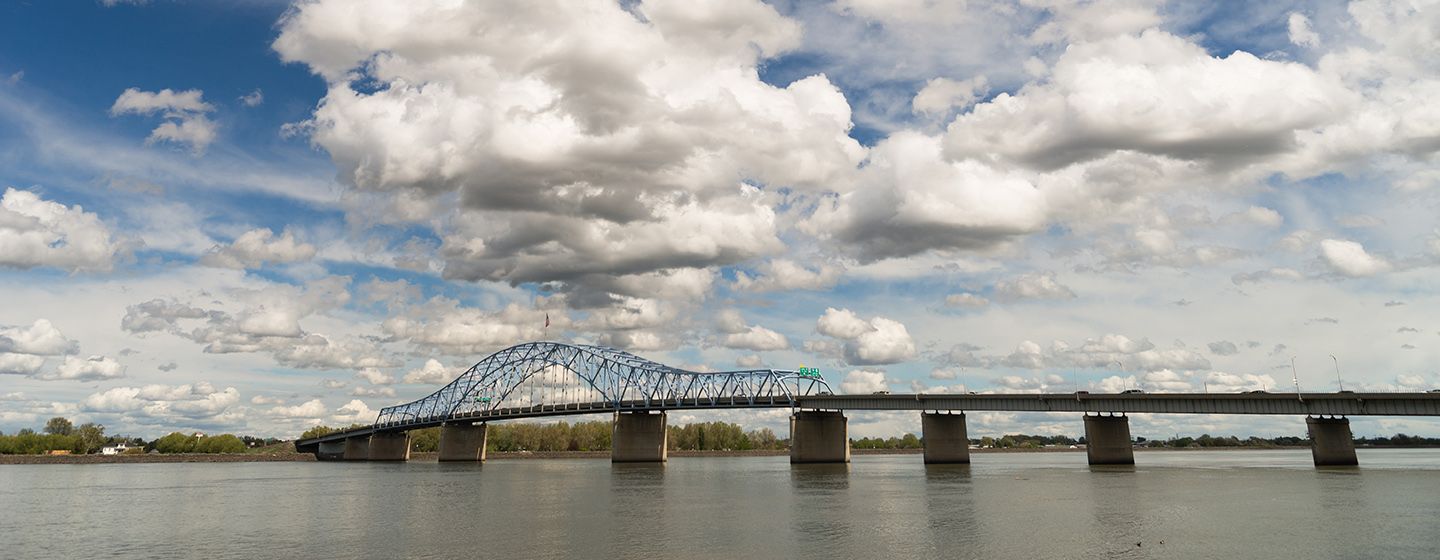 Bridge over a river with big clouds in the sky in Washington.
