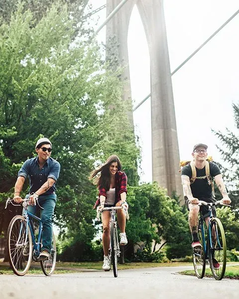 A physician, a white man, on his day off, riding a bike recreationally with friends, a man and a woman.